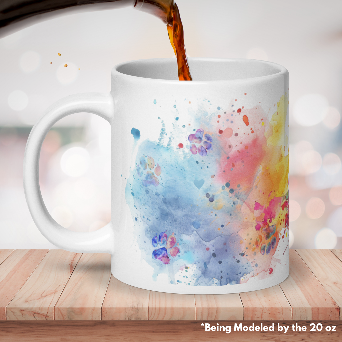 The other side or back of our 20 oz mug. The artwork wraps completely around the mug give bright and colorful happiness to the space. Mug is on a wooden surface with blurred starry lights behind and coffee being poured in.