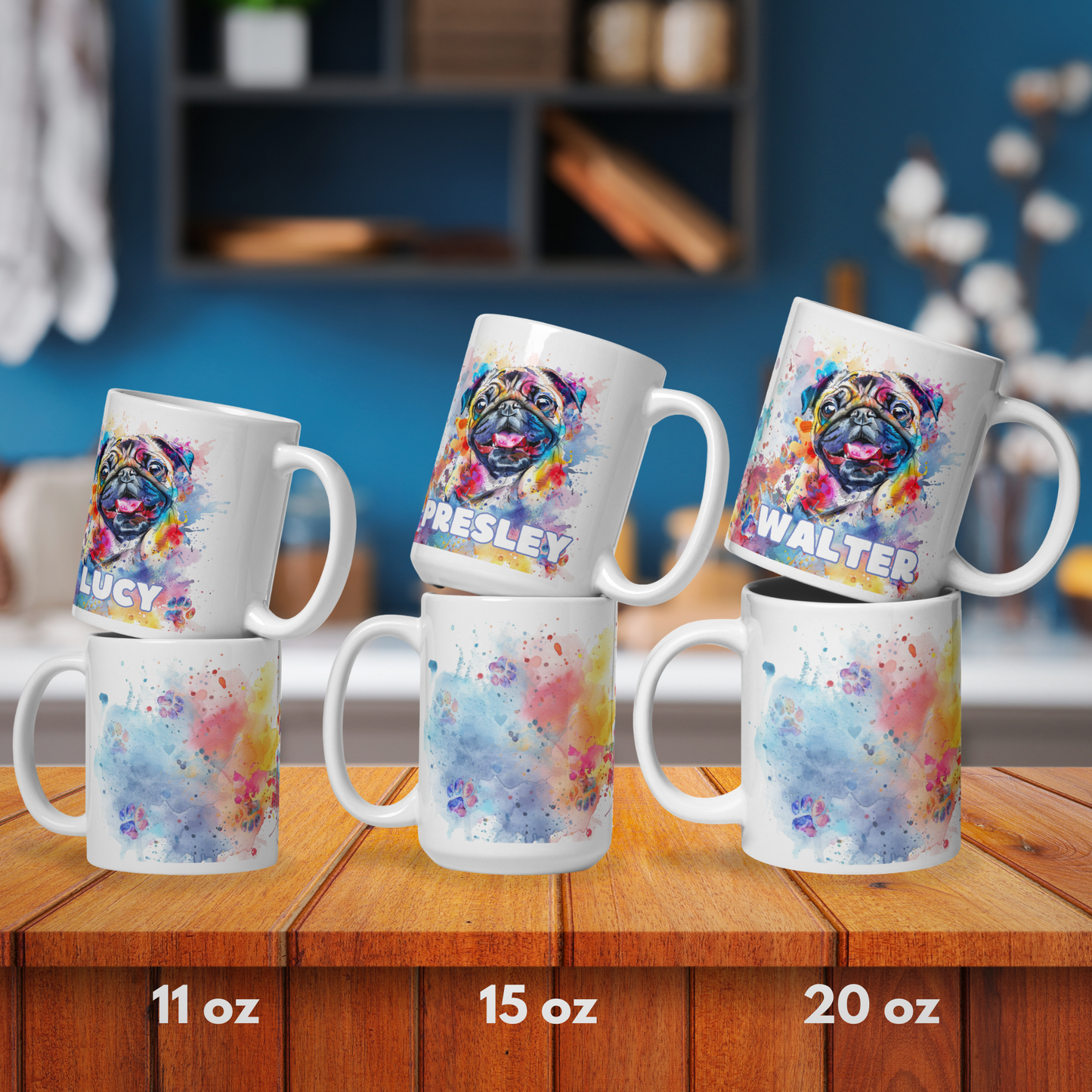 The entire size line put together for a rough comparison. This mug comes in 11 oz, 15 oz, and 20 oz. The mugs are lined up to show the front and back of the mugs. They are wooden surface with a blue kitchen wall behind them.