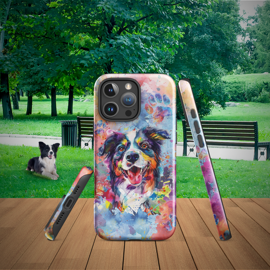 Border Collie iPhone Case with watercolor art, showing side and bottom of a iPhone 16 Pro Max model. Set on a picnic table with a park and a Border Collie (Dog) behind it. This case is durable and very colorful. It is a great accessory at all parks!