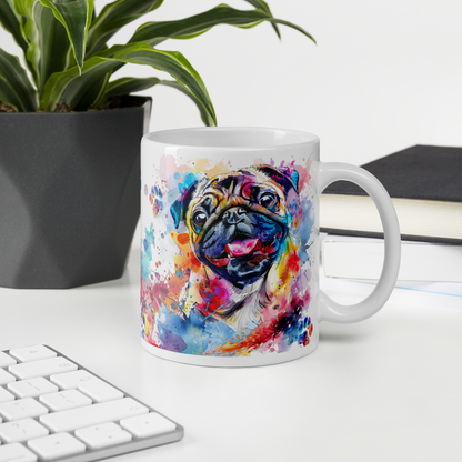 Doggone Proud Pug 15 oz Mug. A fun mug with a happy Pug dog surrounded by watercolor splashes, clouds, and paws. Mug is on a white desk with a plant book and keyboard. Great give for any dog lover or paw-rent.