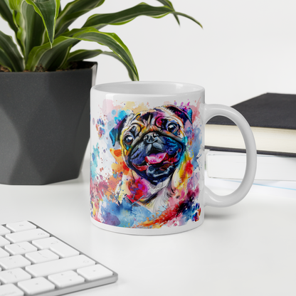 Doggone Proud Pug 11 oz Mug. A fun mug with a happy Pug dog surrounded by watercolor splashes, clouds, and paws. Mug is on a white desk with a plant book and keyboard. Great give for any dog lover or paw-rent.