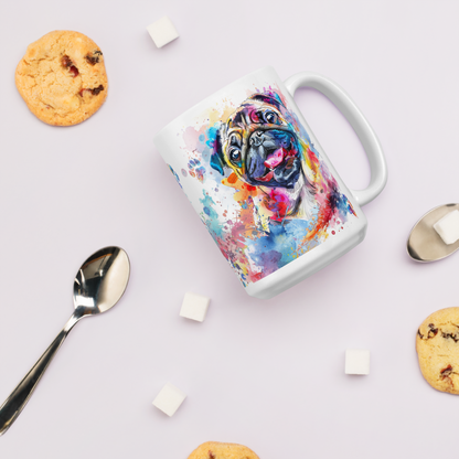 Doggone Proud Pug Dog Mug. A fun colorful mug with handle showing a happy Pug dog surrounded by watercolor splashes, clouds, and paws. Mug is laying flat with cookies around it.