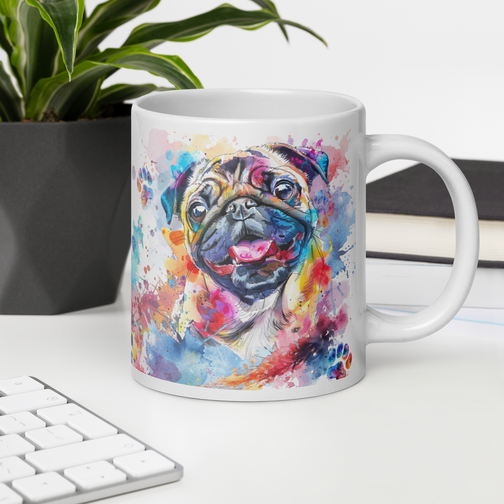 Doggone Proud Pug 20 oz Large Big Mug. A fun mug with a happy Pug dog surrounded by watercolor splashes, clouds, and paws. Mug is on a white desk with a plant book and keyboard. Great give for any dog lover or paw-rent.